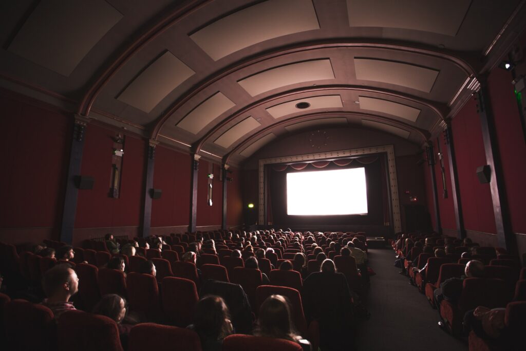 Ihmisiä vanhanaikaisessa elokuvateatterissa. 