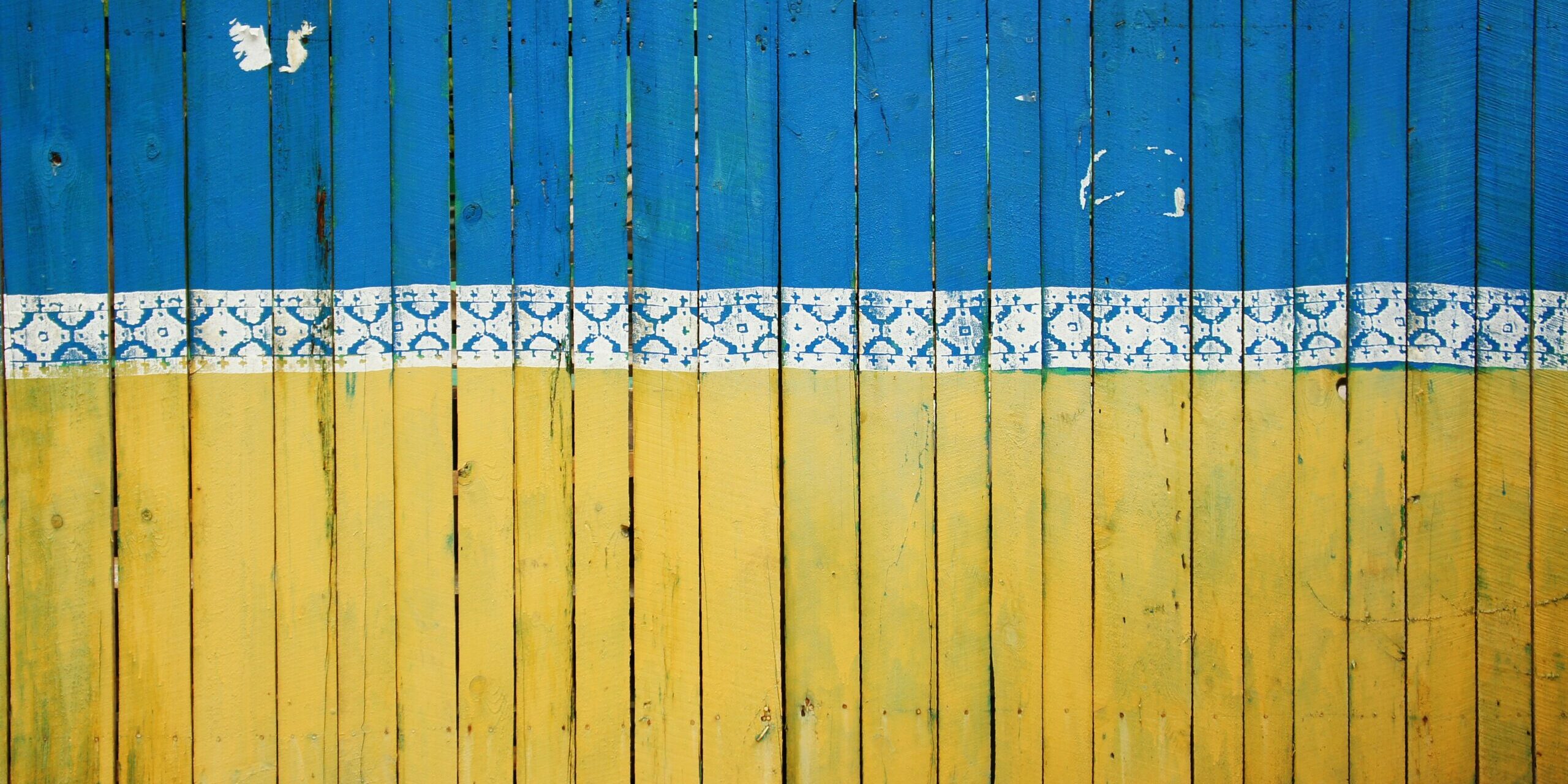 tina-hartung-IwLY-pLic_U-unsplash Kuvassa on puuaita, joka on maalattu Ukrainan lipun värein ylhäältä siniseksi ja alhaalta keltaiseksi.